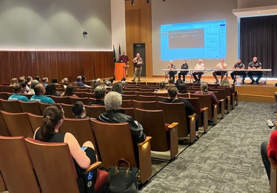 Panel of speakers on a stage at an event.