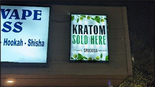 Photo of a sign on a store advertising "Kratom sold here"