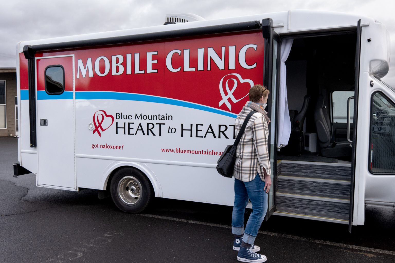 A client walks up to a mobile clinic to receive care.