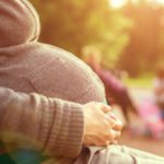 Pregnant woman sitting on bench