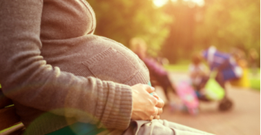 Pregnant woman sitting on bench