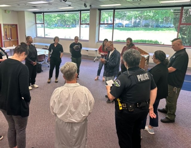 Group of people standing in a circle talking