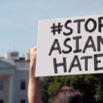 Person holding up sign reading Stop Asian Hate