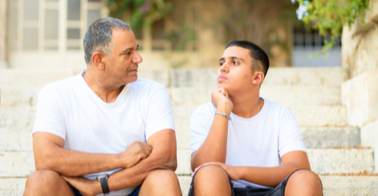 Father talking to son on steps